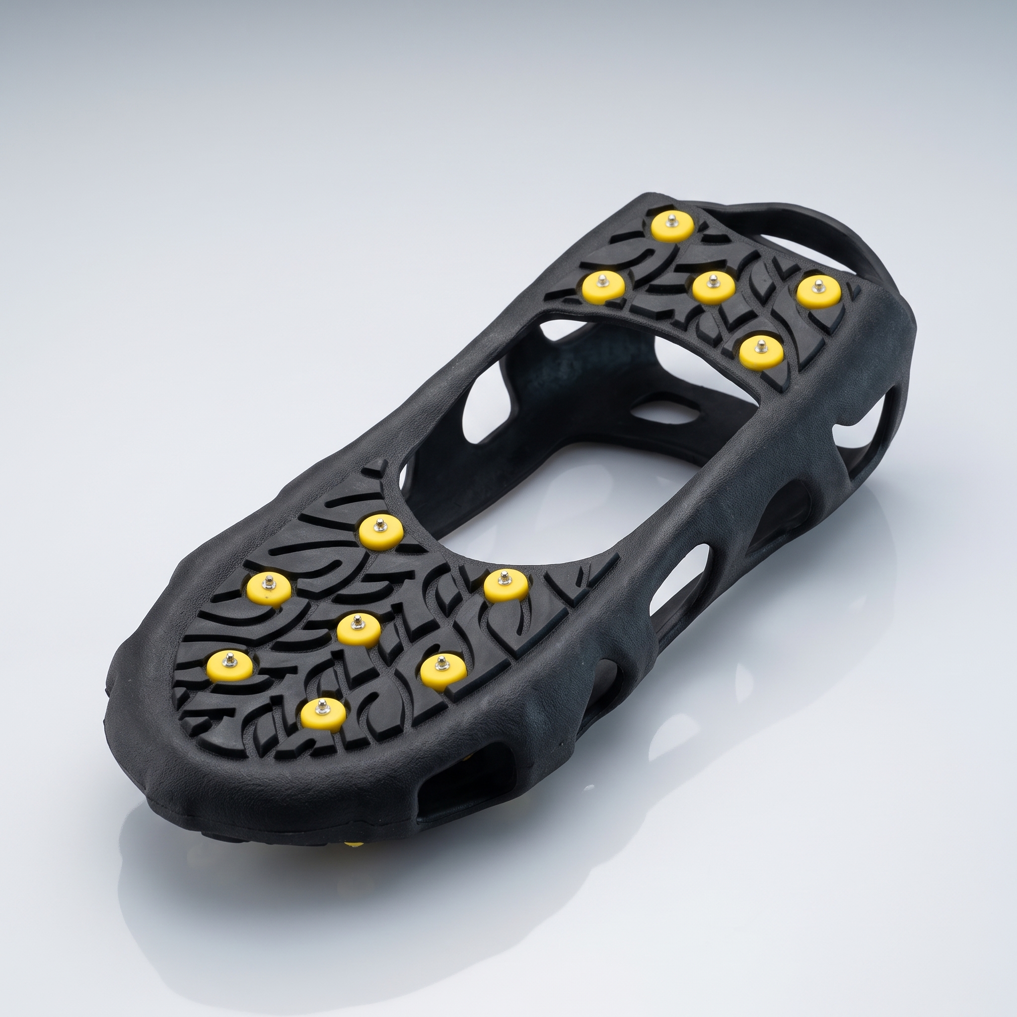 Ice fishing cleats showing steel studs and coil-style traction devices attached to boots